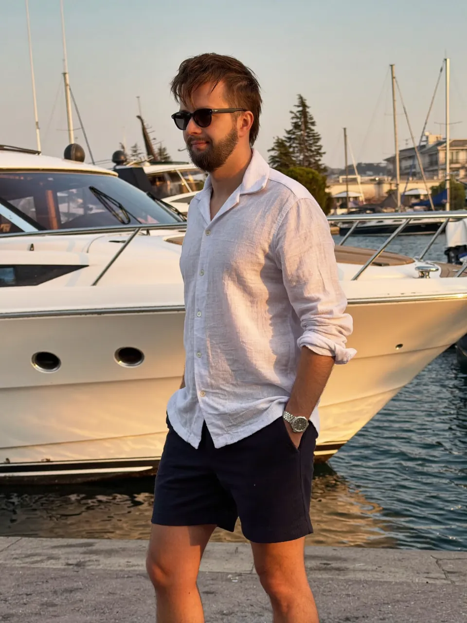 Michael Rebel in a white shirt at a marina.